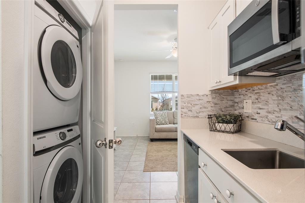 1172 Tyler Loop Lake Wales, FL 33859 - Photo 39 of 56 a kitchen with sink a washer and dryer
