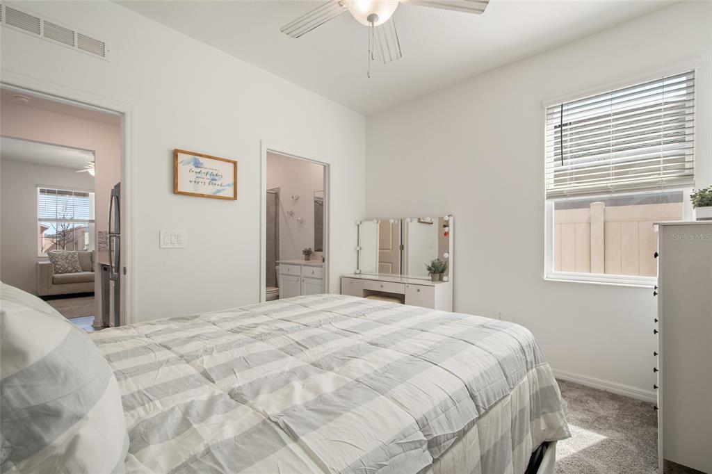 1172 Tyler Loop Lake Wales, FL 33859 - Photo 42 of 56 a bedroom with a large bed and a chandelier