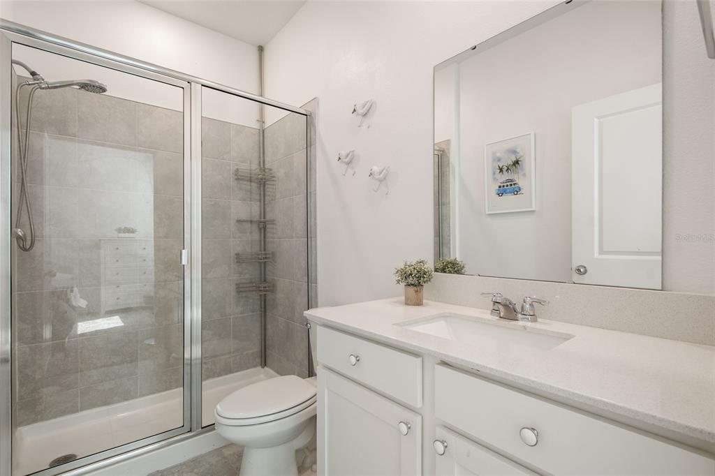 1172 Tyler Loop Lake Wales, FL 33859 - Photo 43 of 56 a bathroom with a granite countertop sink toilet and shower