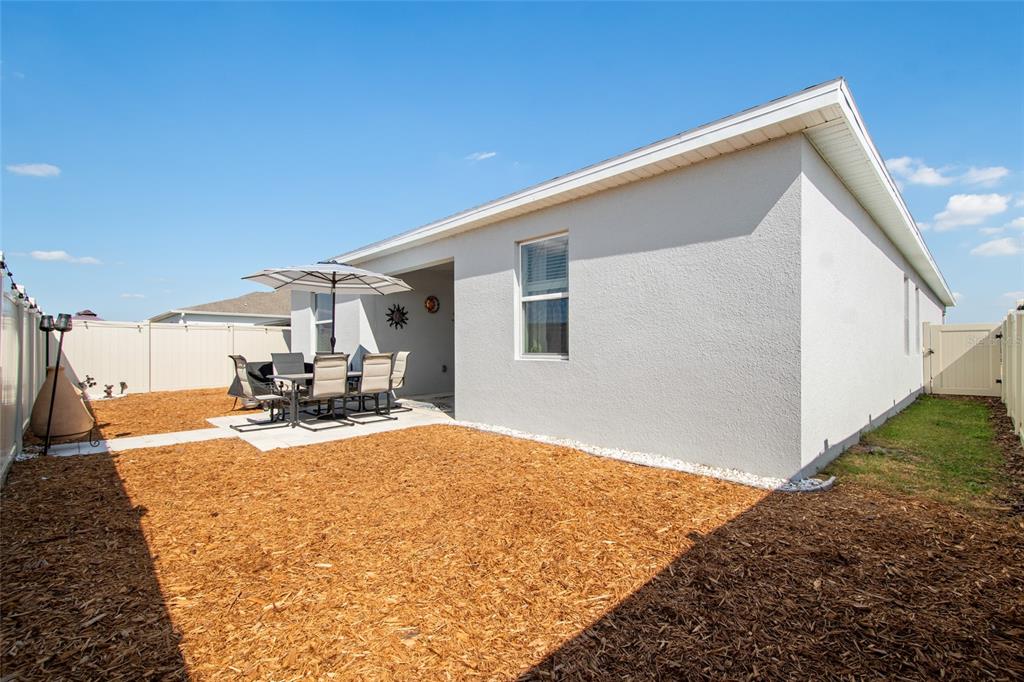 1172 Tyler Loop Lake Wales, FL 33859 - Photo 48 of 56 a view of a house with backyard and a patio
