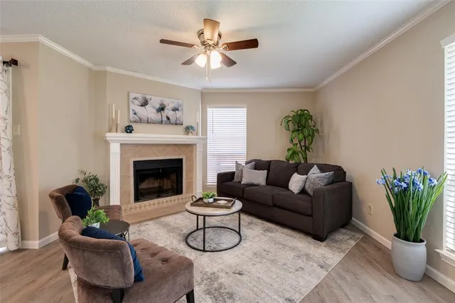 a living room with furniture a chandelier and a fireplace