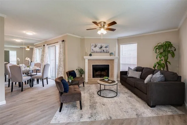 a living room with furniture a fireplace and a potted plant