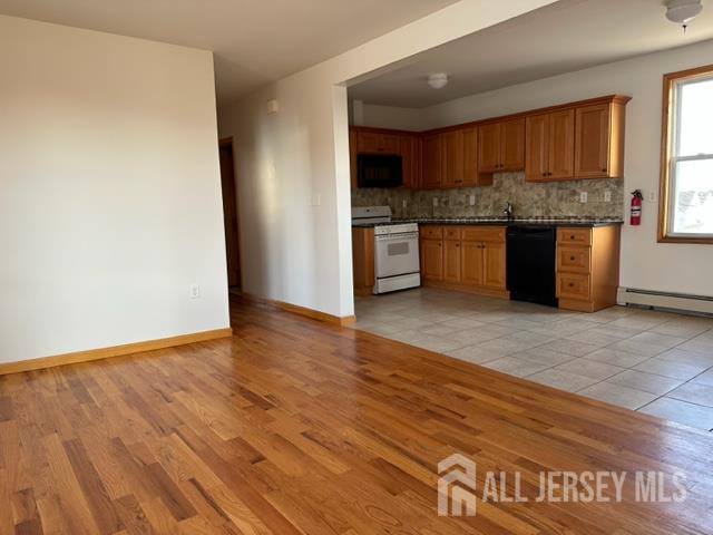 321 Pershing Avenue, Unit 2 Carteret, NJ 07008 - Photo 1 of 16 a kitchen with stainless steel appliances granite countertop a refrigerator sink and cabinets