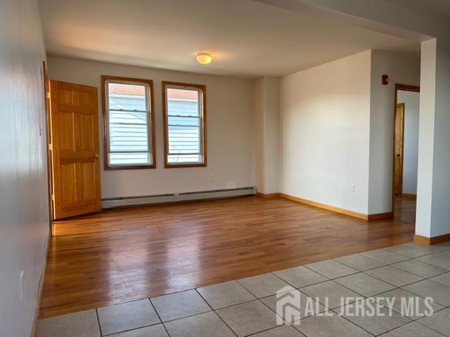 321 Pershing Avenue, Unit 2 Carteret, NJ 07008 - Photo 11 of 16 an empty room with wooden floor and windows