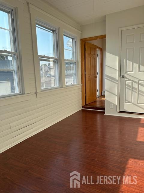 321 Pershing Avenue, Unit 2 Carteret, NJ 07008 - Photo 15 of 16 a view of an empty room with wooden floor and a window