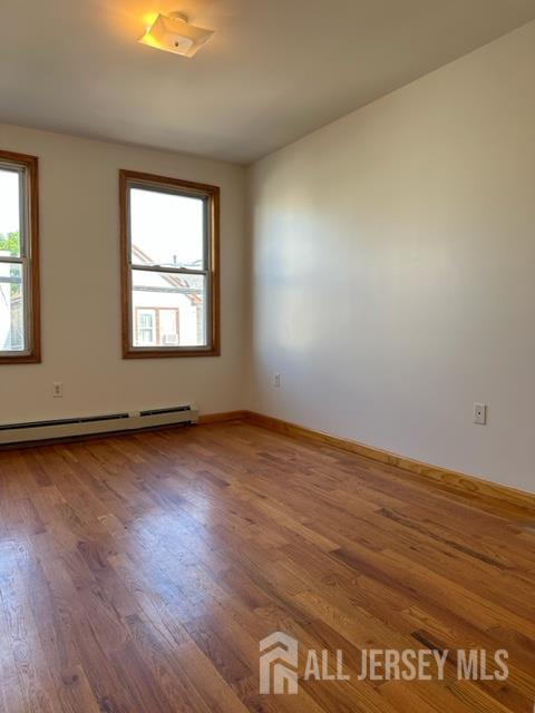 321 Pershing Avenue, Unit 2 Carteret, NJ 07008 - Photo 2 of 16 an empty room with wooden floor and windows