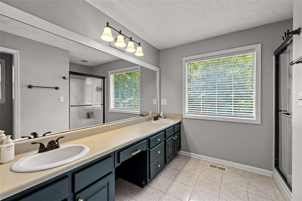 128 Byrom Road Senoia, GA 30276 - Photo 29 of 83 a bathroom with a sink and a mirror