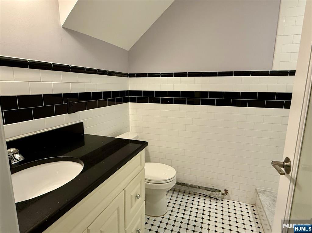 59 Laurel Avenue, Unit RIGHT SIDE Kearny, NJ 07032 - Photo 14 of 16 a bathroom with a granite countertop sink toilet and shower