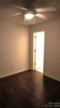 a view of a room with wooden floor and a window