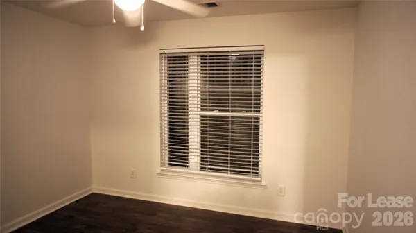 a view of wooden floor and a window