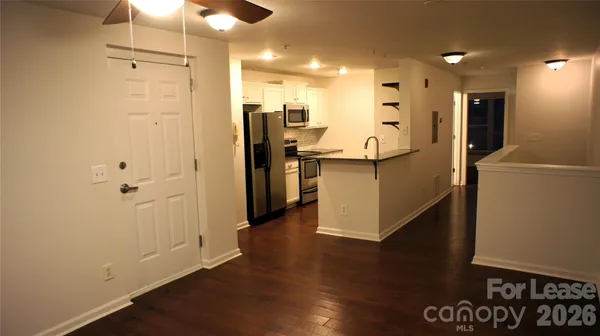 a kitchen with stainless steel appliances refrigerator and microwave