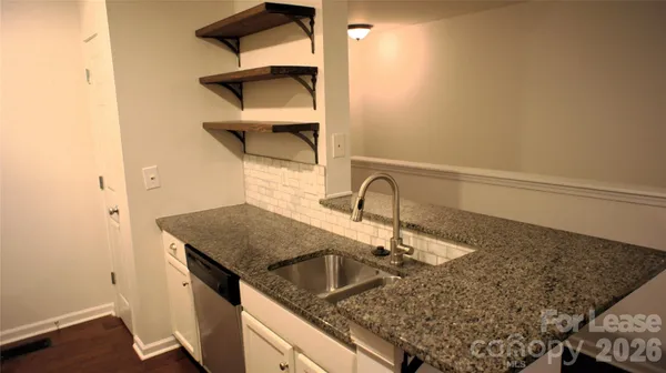 a kitchen with a sink and cabinets