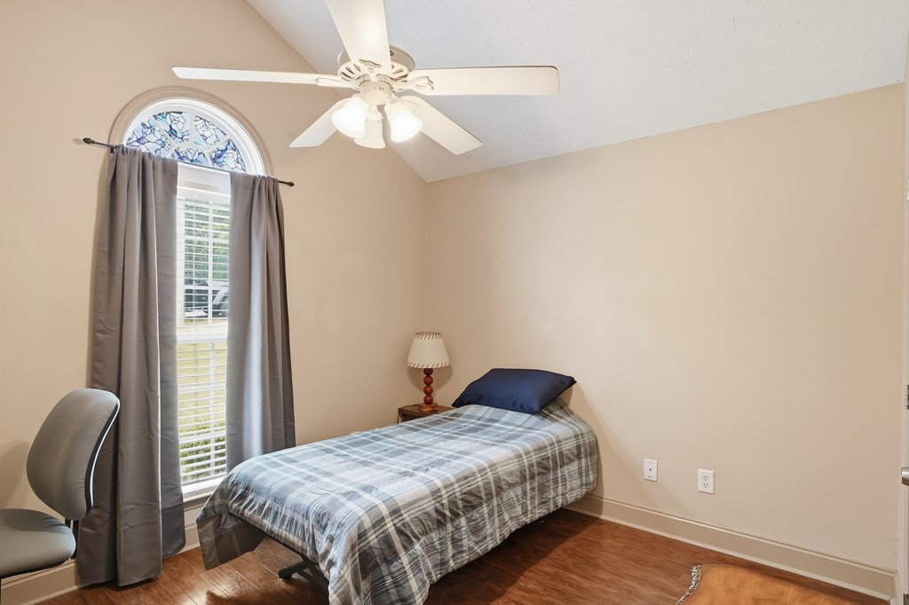 5019 Mccaghren Drive Columbus, GA 31909 - Photo 12 of 22 a bedroom with a bed and a chandelier