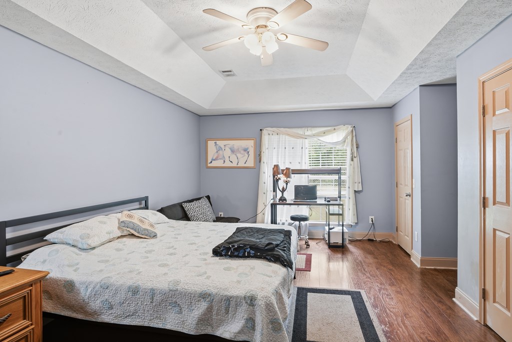5019 Mccaghren Drive Columbus, GA 31909 - Photo 13 of 22 a bedroom with a bed and a chandelier