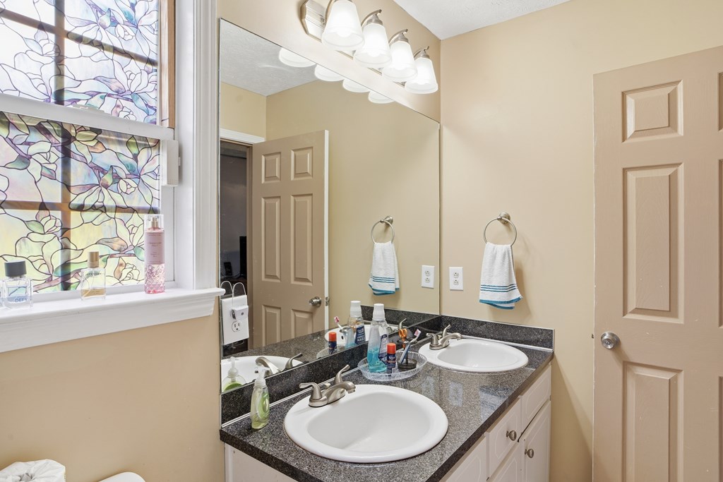 5019 Mccaghren Drive Columbus, GA 31909 - Photo 15 of 22 a bathroom with a double vanity sink and a mirror