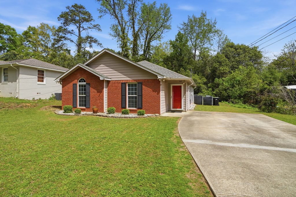 5019 Mccaghren Drive Columbus, GA 31909 - Photo 22 of 22 a view of a yard in front of a house with plants and large tree
