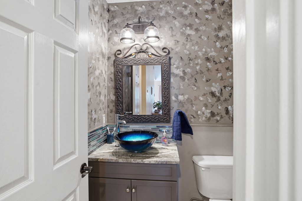 5019 Mccaghren Drive Columbus, GA 31909 - Photo 9 of 22 a bathroom with a toilet a sink and mirror