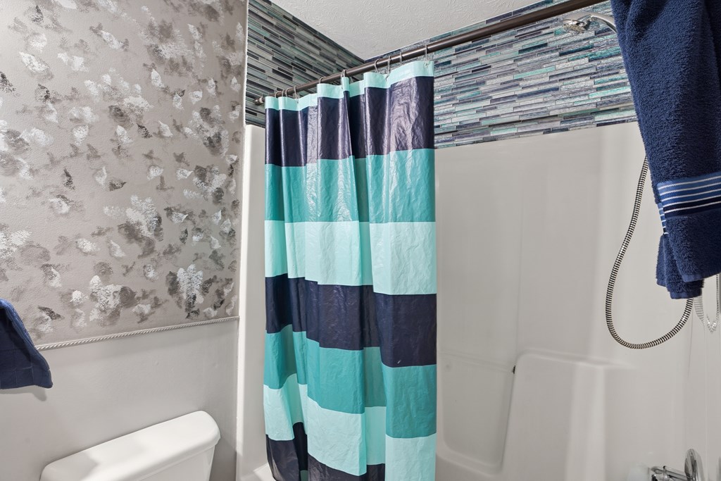 5019 Mccaghren Drive Columbus, GA 31909 - Photo 10 of 22 a bathroom with a shower toilet and sink