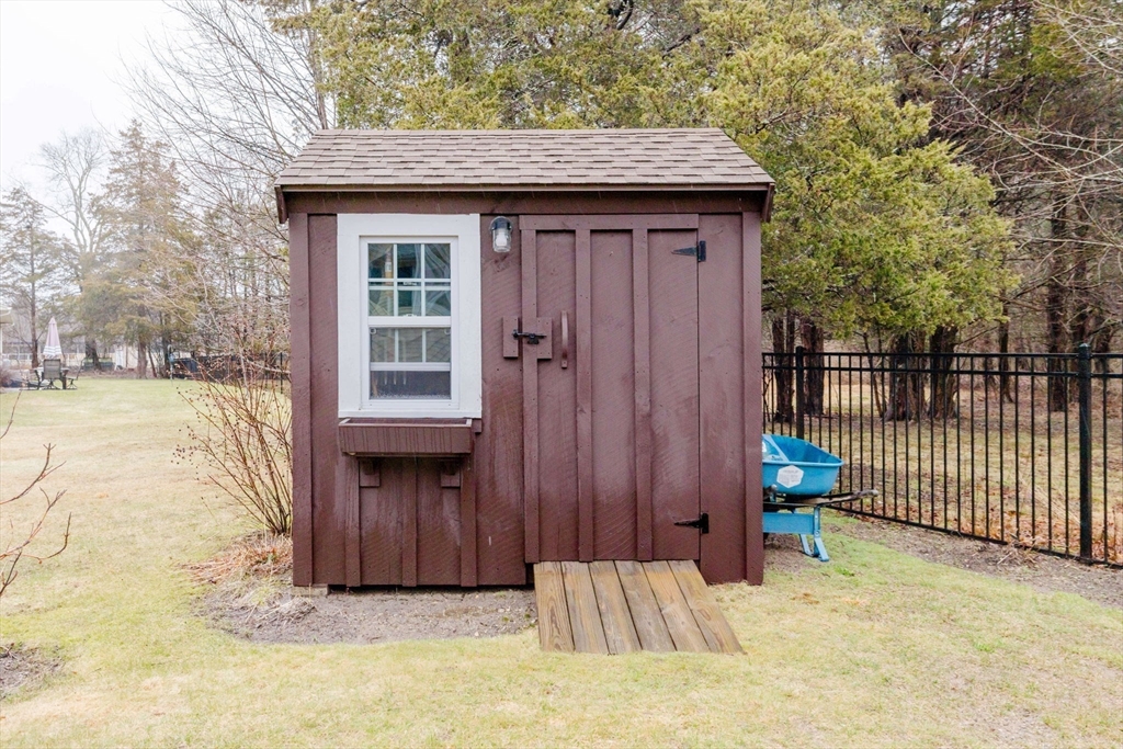 15 Ralsie Road Rehoboth, MA 02769 - Photo 4 of 32 a view of a house with a wooden bench in a backyard