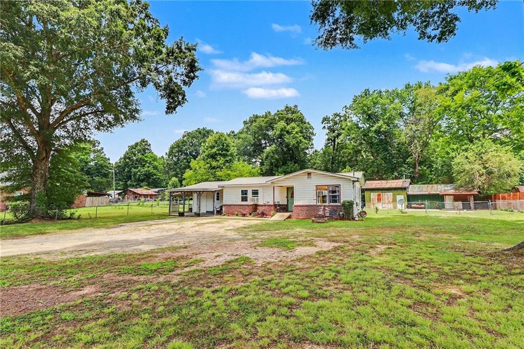 381 River Bend Road Southwest Plainville, GA 30733 - Photo 3 of 28 a front view of a house with a yard