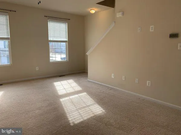 an empty room with windows and entrance