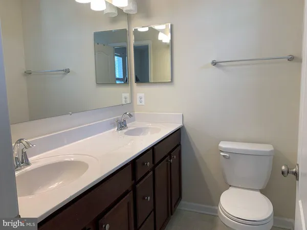 a bathroom with a sink a toilet and mirror