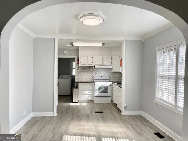 a kitchen with a sink and a stove top oven