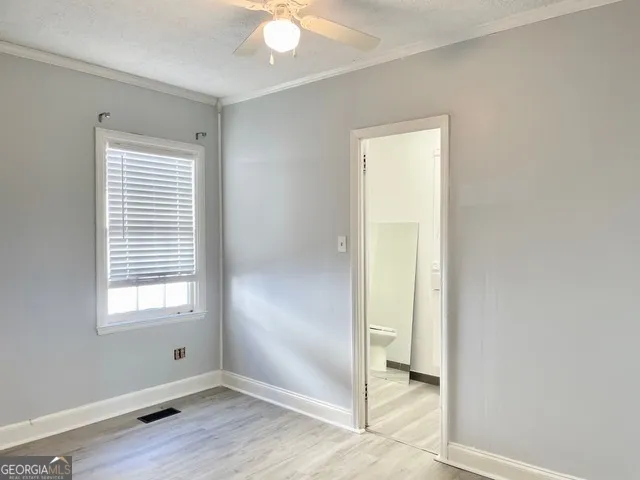 a bathroom with a toilet a sink and a window