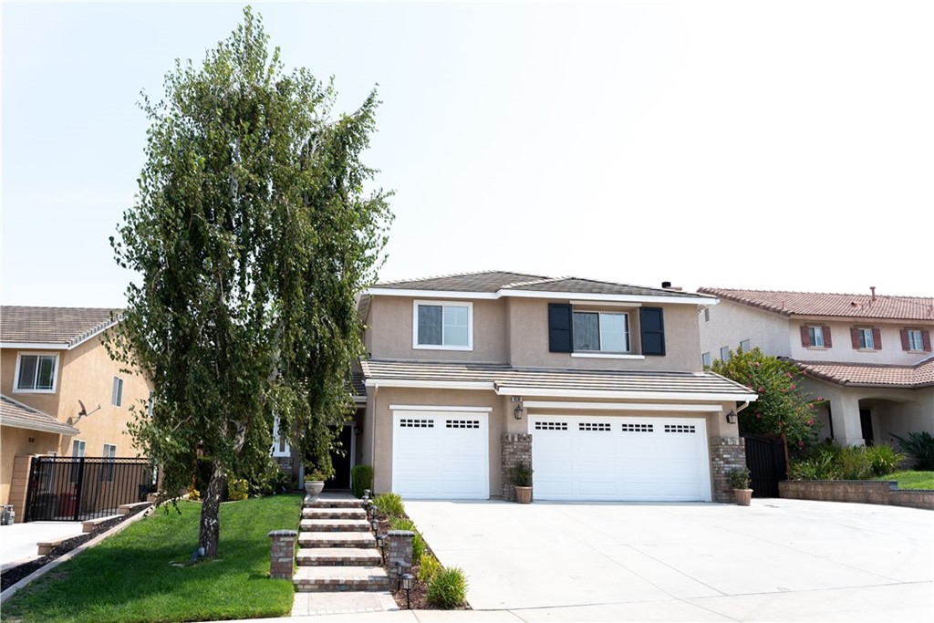 8536 New Windsor Street Riverside, CA 92508 - Photo 1 of 1 a front view of a house with a yard