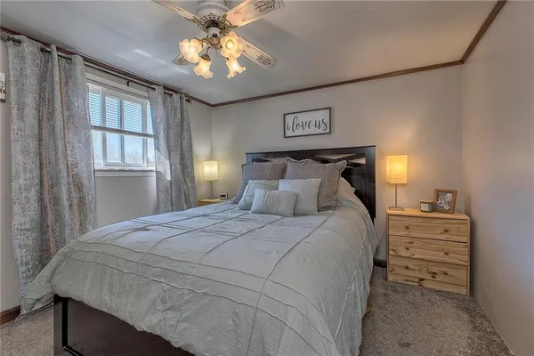 a bedroom with a bed and a lamp on dresser