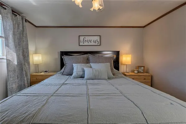 a bedroom with a bed and a chandelier