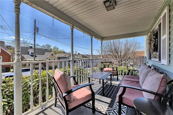 a view of a chairs and table in the balcony