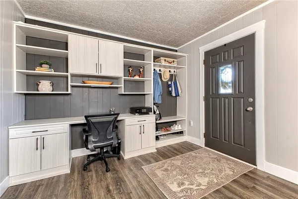 a living room with furniture a flat screen tv and a lamp