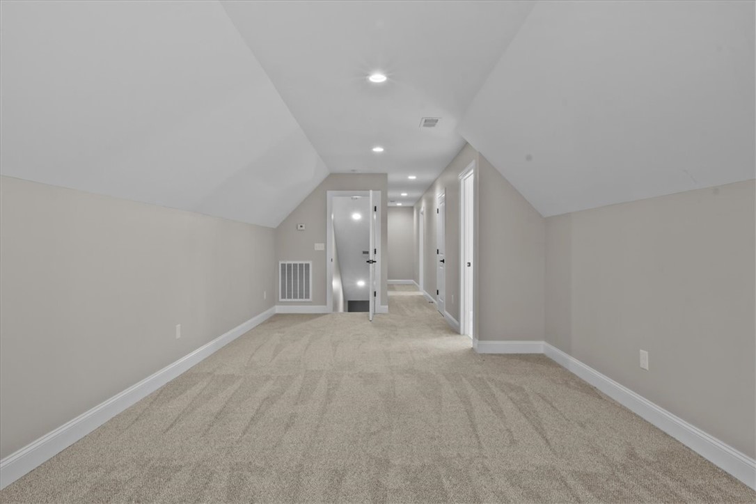 105 Bree Drive Anderson, SC 29621 - Photo 25 of 48 A spacious, naturally illuminated attic features inviting carpeting and practical recessed lighting.