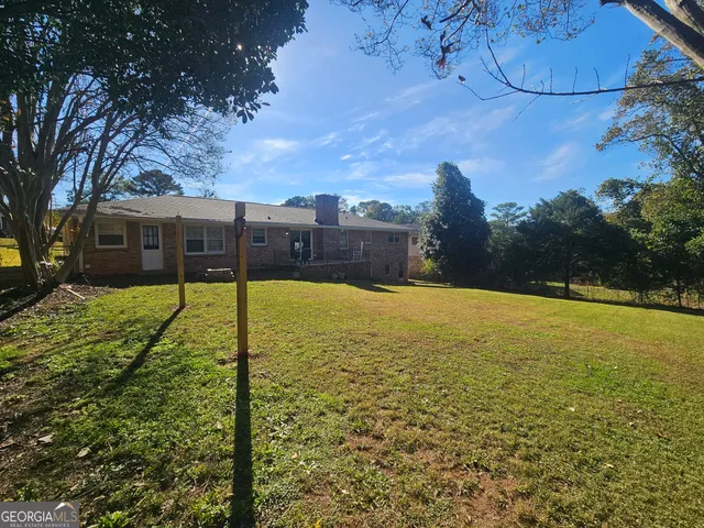 a view of a swimming pool with a yard