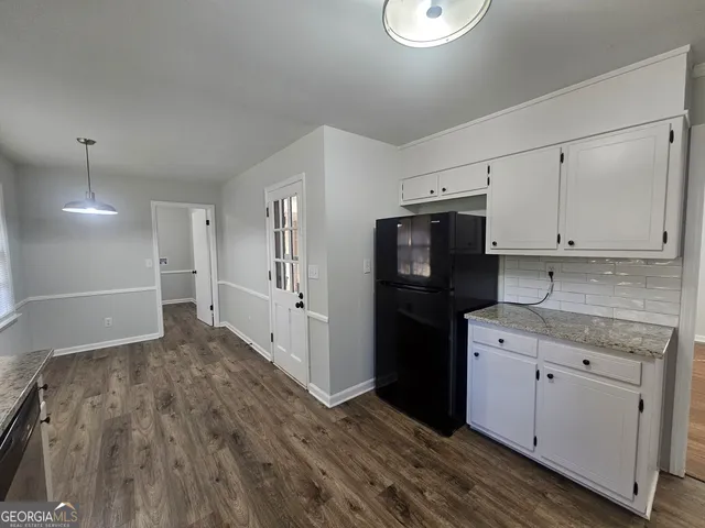 a kitchen with stainless steel appliances granite countertop a refrigerator and a stove top oven