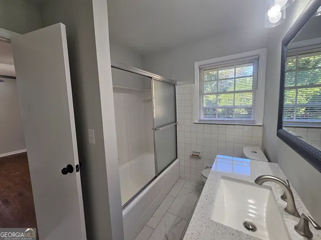 a bathroom with a tub and shower