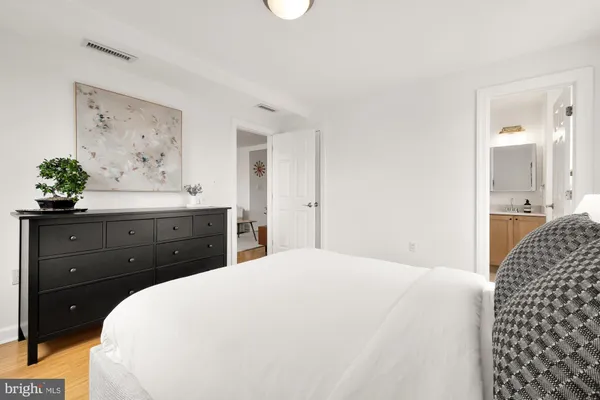 a spacious bedroom with a bed and a chandelier