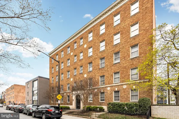 a city street lined with buildings and cars