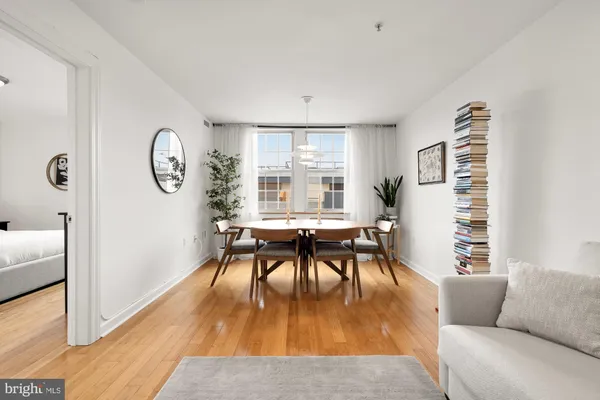 a living room with furniture a table and a large window