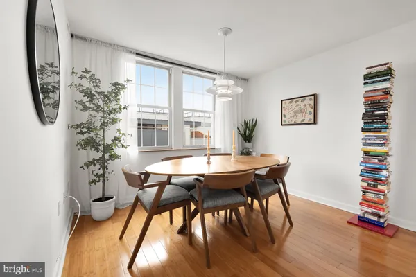 a view of a dining room with furniture window and wooden floor