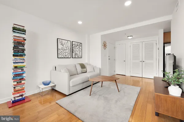 a living room with furniture and wooden floor