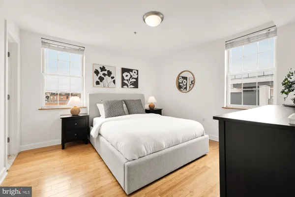 a bedroom with a large bed and a window