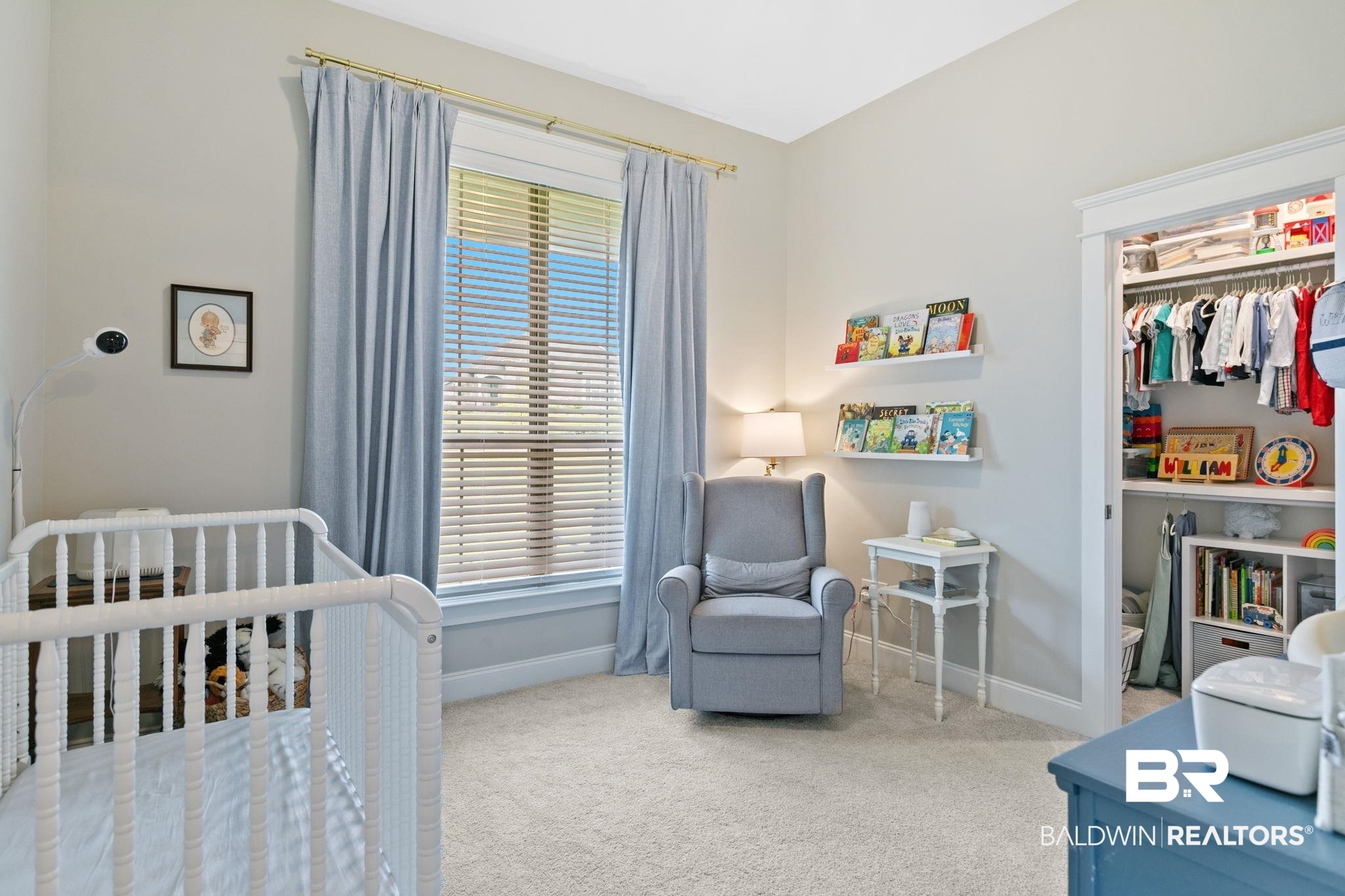 13233 Ibis Boulevard Daphne, AL 36527 - Photo 38 of 100 Carpeted room featuring a large window with horizontal blinds, a built-in closet with shelving and hanging space, and light-colored walls
