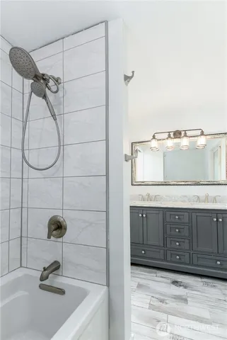 a bathroom with a sink vanity and a mirror