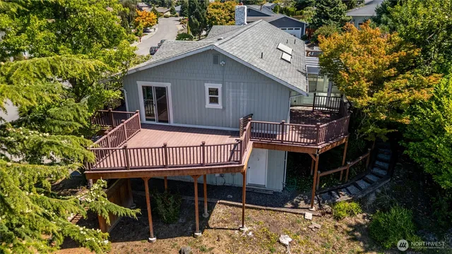 an aerial view of a house with a yard basket ball court and outdoor seating