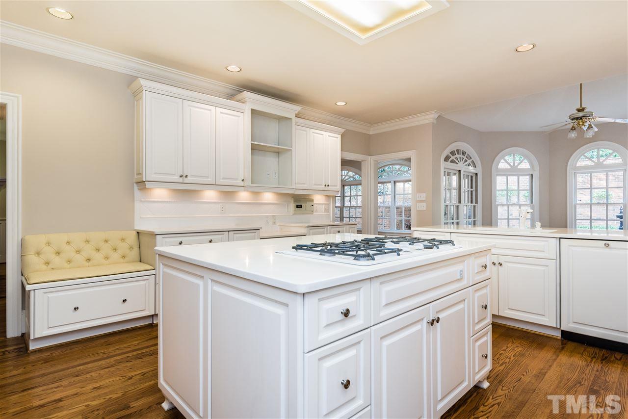 3103 Landor Road Raleigh, NC 27609 - Photo 11 of 25 a kitchen with cabinets appliances a sink and a counter top space