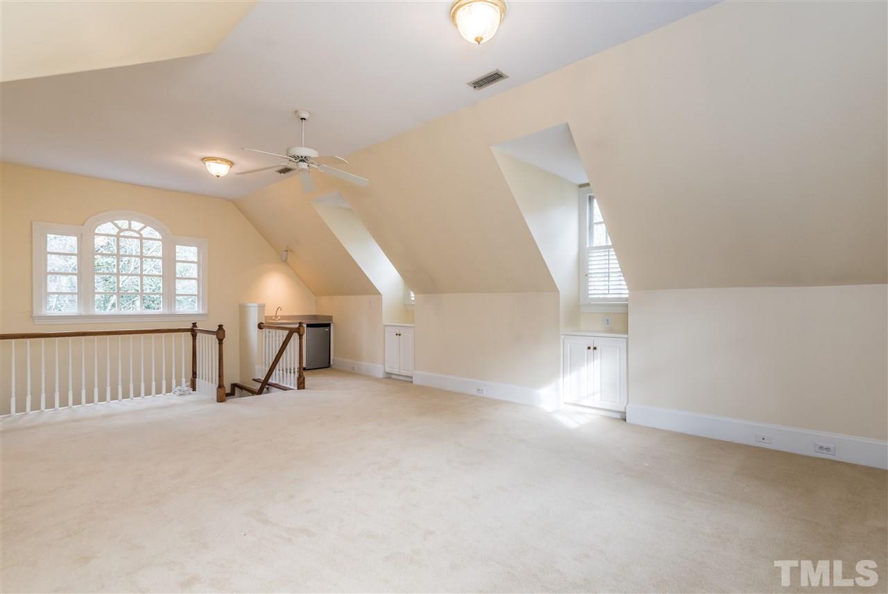 3103 Landor Road Raleigh, NC 27609 - Photo 21 of 25 an empty room with stairs and windows