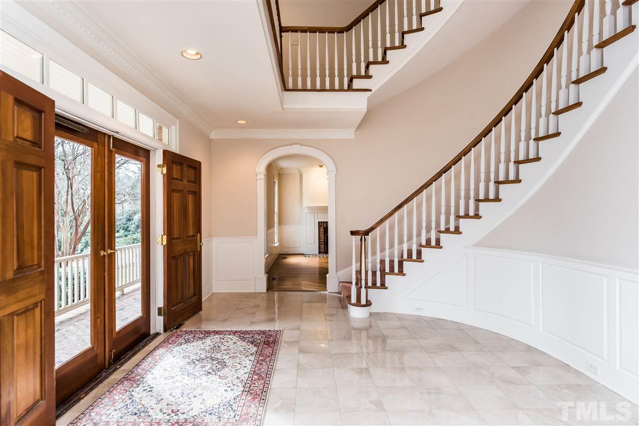 3103 Landor Road Raleigh, NC 27609 - Photo 4 of 25 a view of staircase with lots of frames and couches