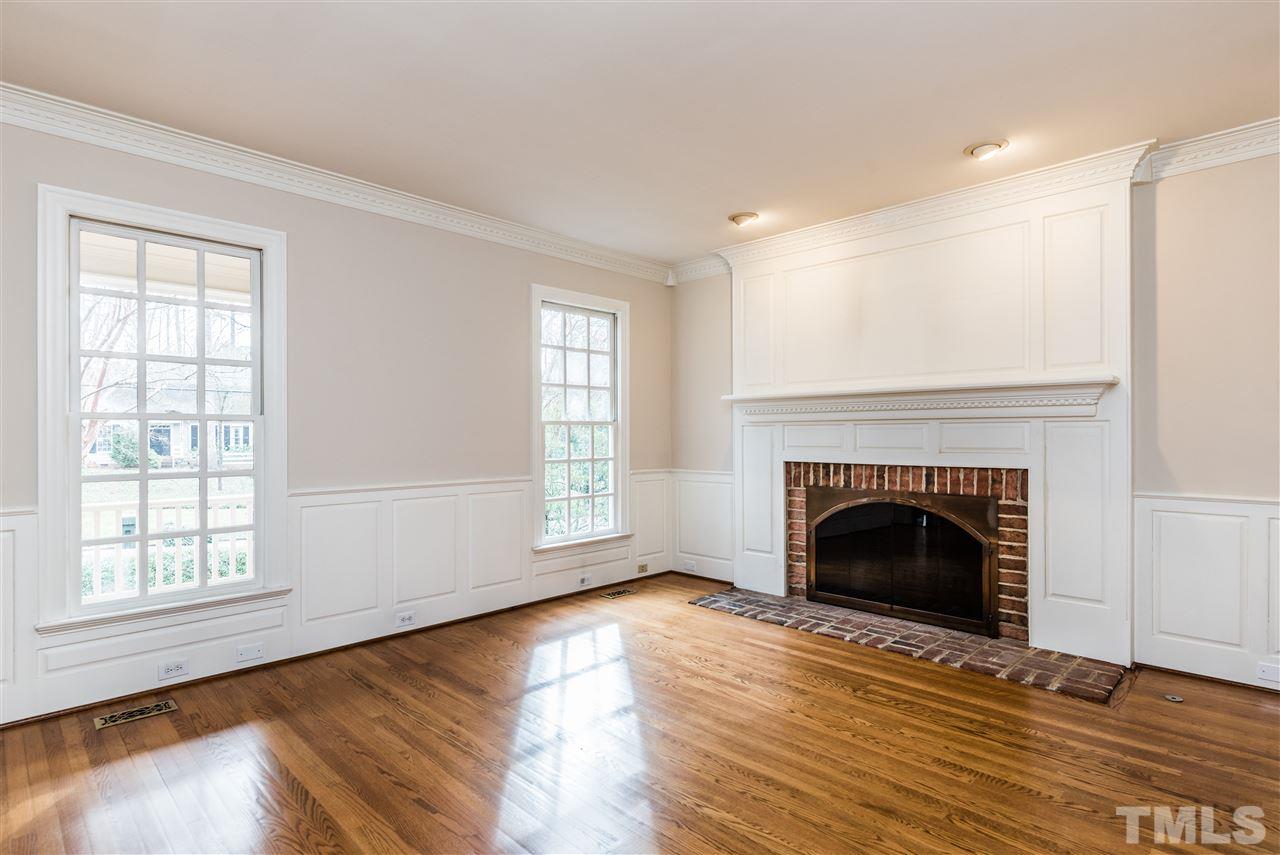 3103 Landor Road Raleigh, NC 27609 - Photo 5 of 25 a living room with fireplace and wooden floor